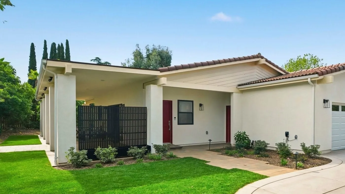Wide concrete driveway leading to the garage of a single-story stucco home